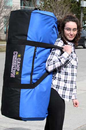 Camper carrying a new camp duffel bag