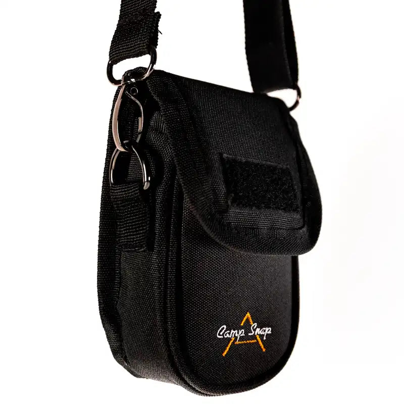 Black camera bag with shoulder strap, featuring the 'Camp Snap' logo.