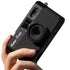 Hand holding a black Camp Snap camera phone case