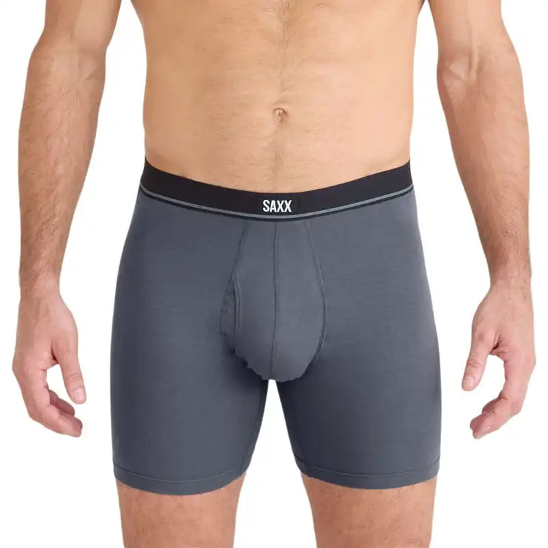 Man wearing Grey boxer briefs with a black waistband featuring the SAXX logo