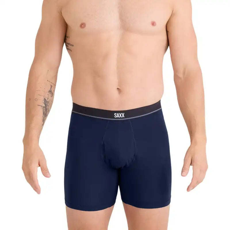 Man Wearing Navy blue boxer briefs with a black waistband featuring 'SAXX' branding