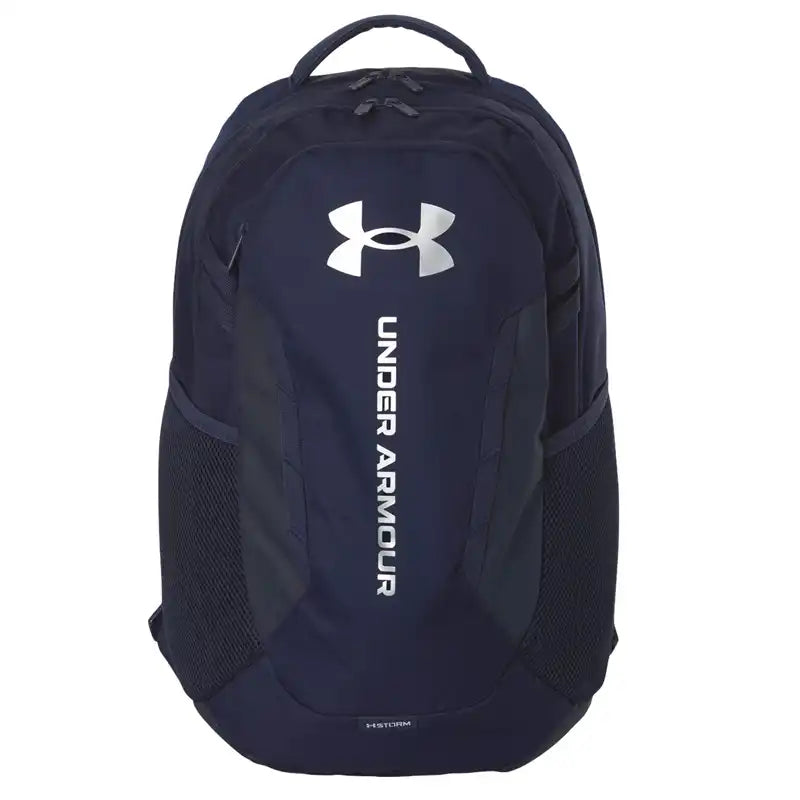 A dark navy blue Under Armour backpack with a large white logo and vertical 'UNDER ARMOUR' text on the front, 