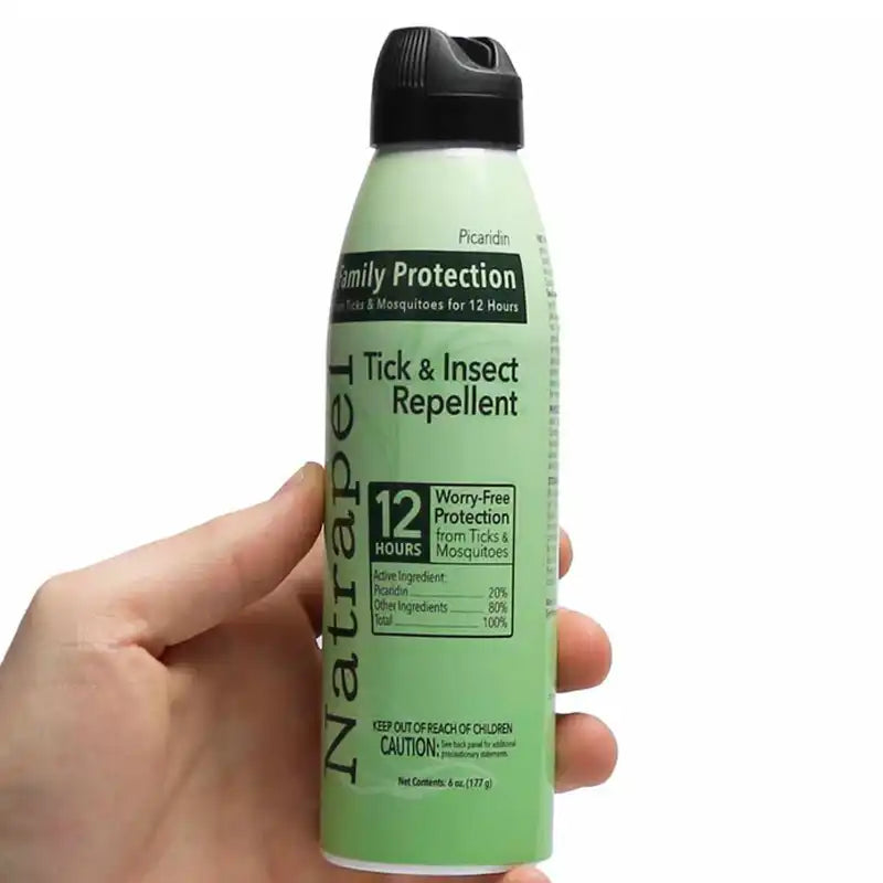 Hand holding a can of Natrapel Tick & Insect Repellent