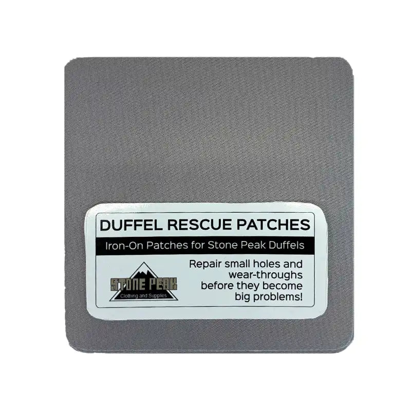 A square gray fabric patch with rounded corners and a white label reading 'DUFFEL RESCUE PATCHES' and 'Iron-On Patches for Stone Peak Duffels.' The label also shows the Stone Peak logo and text about repairing small holes and wear-throughs.