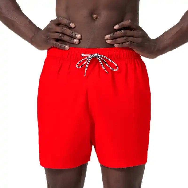 A close-up of bright red Speedo swim trunks with a white drawstring, 