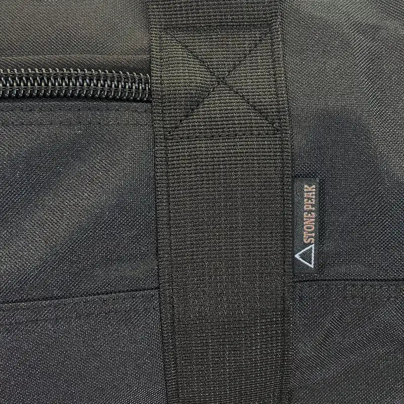 Close-up of a black camp duffel with a zipper and Stone Peak logo.